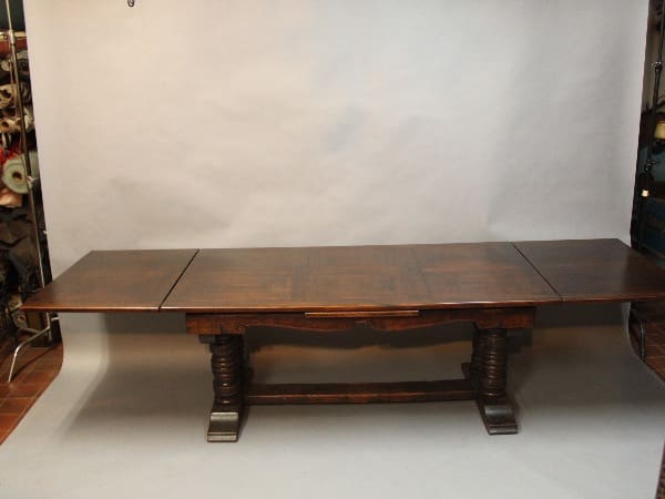 Antique wooden dining table with extensions.