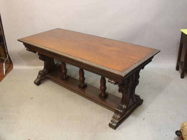 Ornate wooden dining table with carved legs.