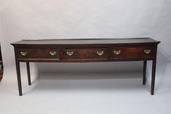 Antique wooden sideboard with four drawers.