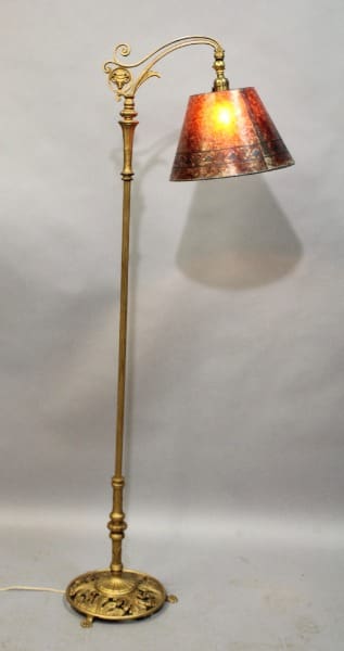 Ornate floor lamp with red patterned shade.