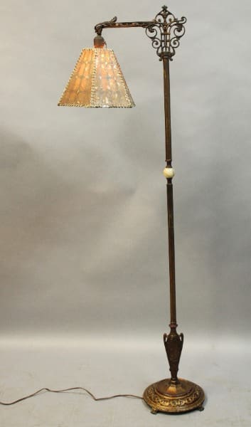 Vintage floor lamp with ornate shade.