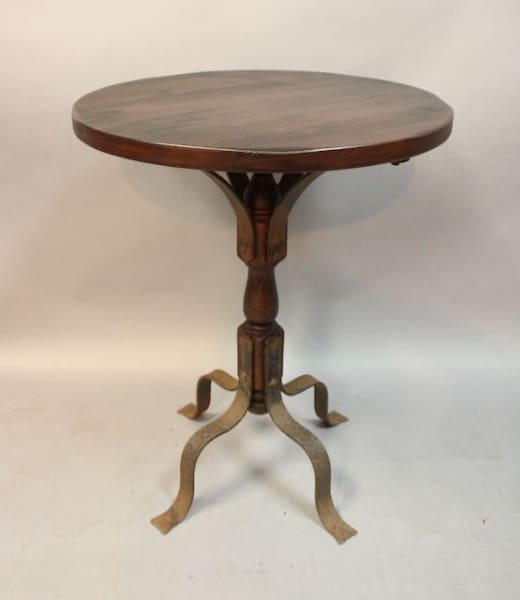 Vintage round wooden pedestal table with tripod base.