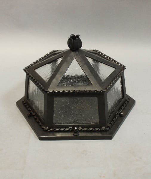 Hexagonal glass lantern with decorative top.