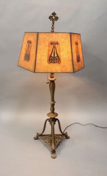 Antique floor lamp with decorative shade.