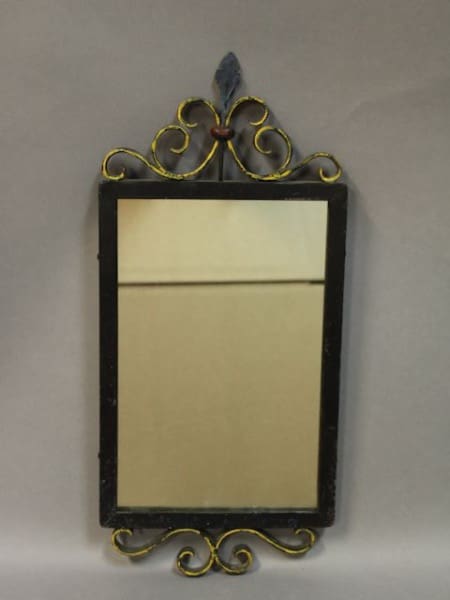 Ornate wall mirror with decorative frame.