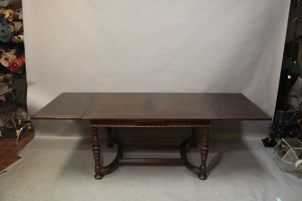 Dark wooden antique extendable dining table.