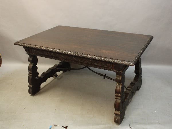 Antique wooden table with ornate carved legs.