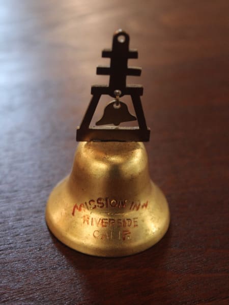 Golden bell with Mission Inn text.