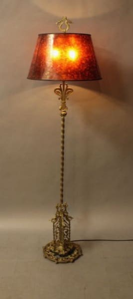 Ornate floor lamp with red lampshade.
