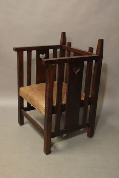 Wooden high chair with heart cutout.