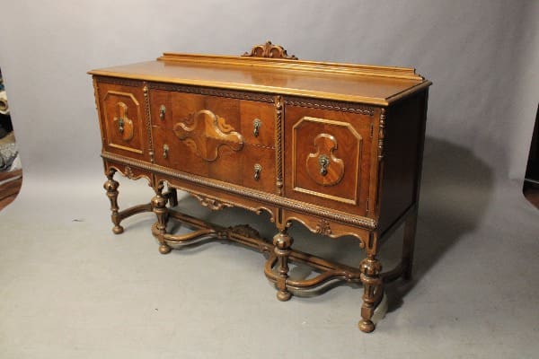 Antique wooden sideboard with ornate carvings.