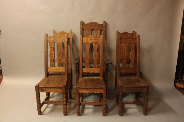 Four vintage wooden chairs in a row.