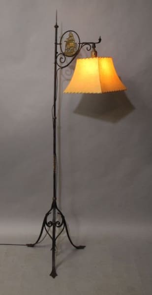 Ornate floor lamp with yellow lampshade.