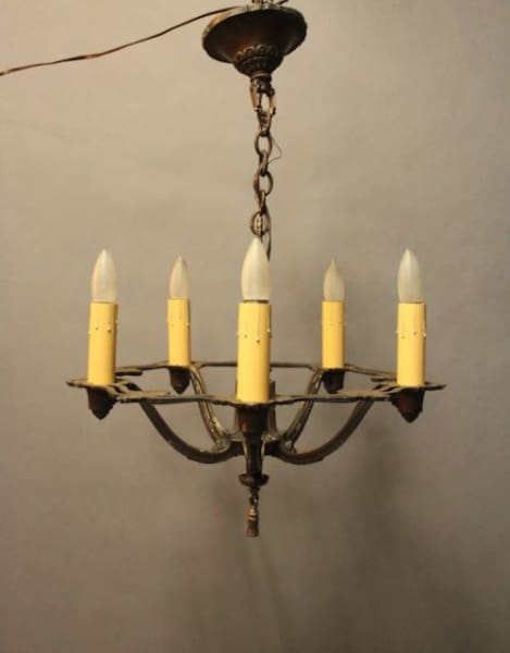 Vintage chandelier with five candle-style lights.
