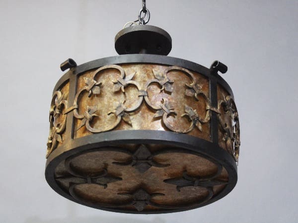Ornate metal chandelier with decorative patterns.