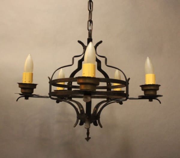 Vintage wrought iron chandelier with candles.