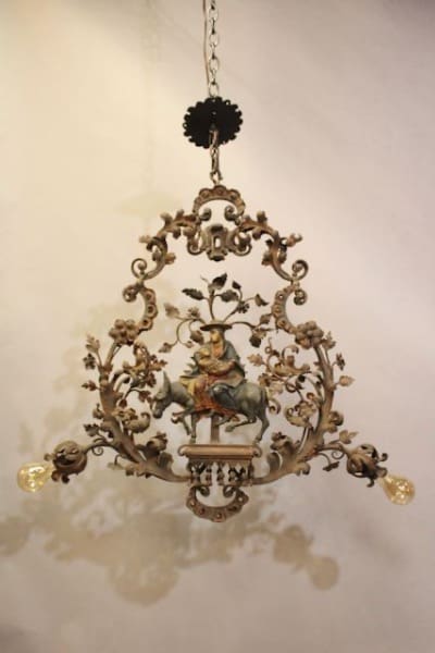 Ornate chandelier with intricate floral design.