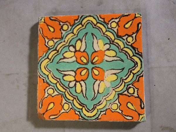 Colorful, ornate floral pattern on ceramic tile.