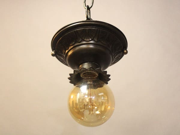 Vintage hanging light fixture with bulb.