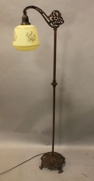 Ornate vintage floor lamp with floral shade.