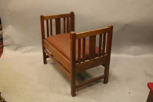 Wooden bench with slatted backrest and seat.