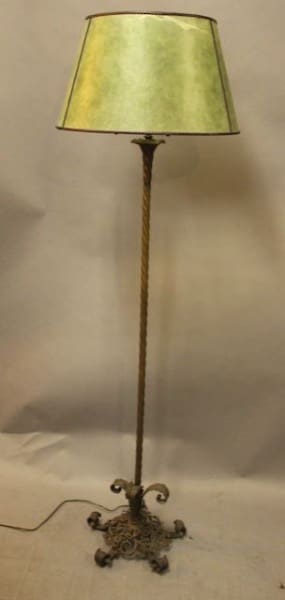 Ornate floor lamp with green lampshade.