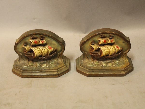 Vintage ship-themed metal bookends on display.