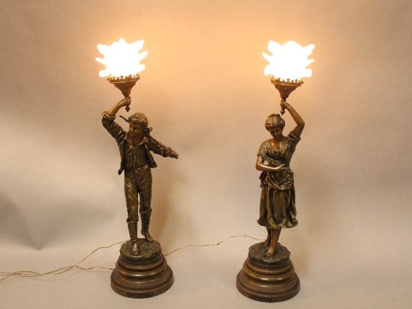 Bronze statue lamps with glowing lights.
