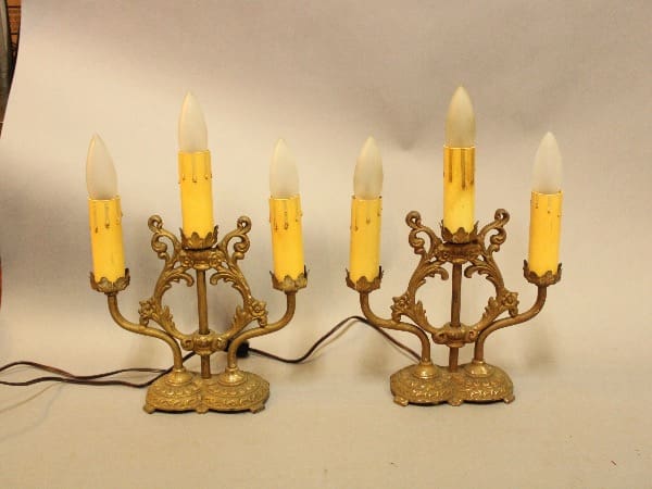 Two ornate vintage candelabra-style electric lamps.