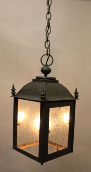 Vintage hanging lantern with glowing bulbs.