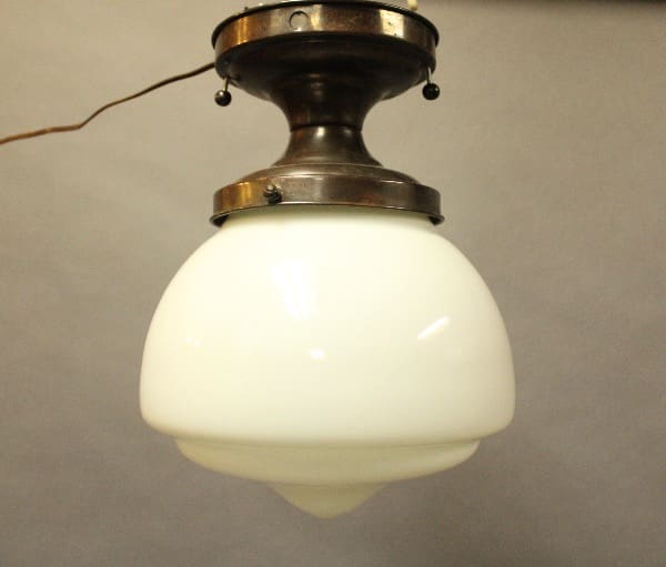 Vintage ceiling light with white glass shade.