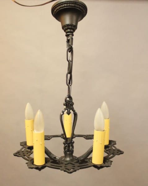 Vintage black chandelier with candle-shaped bulbs.