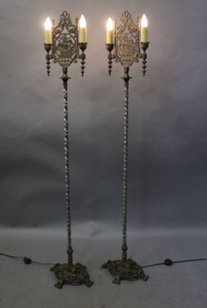 Two ornate vintage floor lamps with lights.