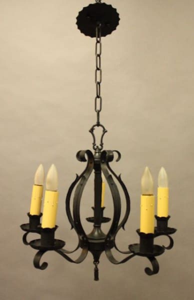 Black wrought iron candle chandelier hanging.