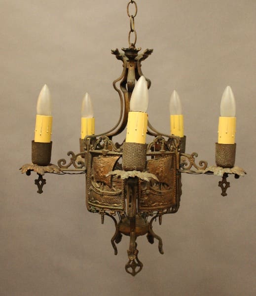 Vintage metal chandelier with five candle lights.