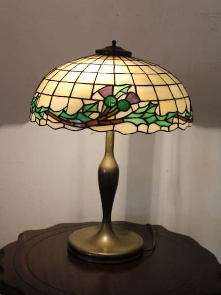 Stained glass lamp on wooden table.