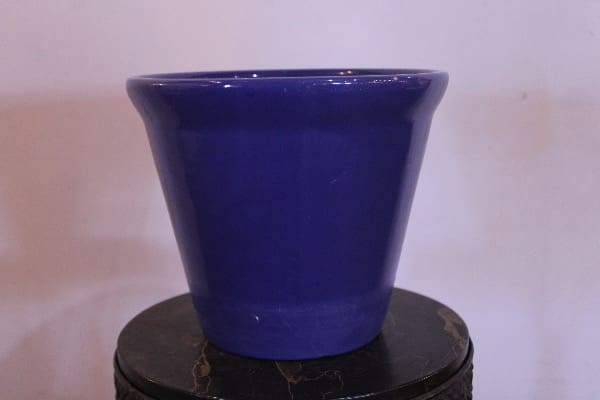 Blue ceramic pot on a dark surface.