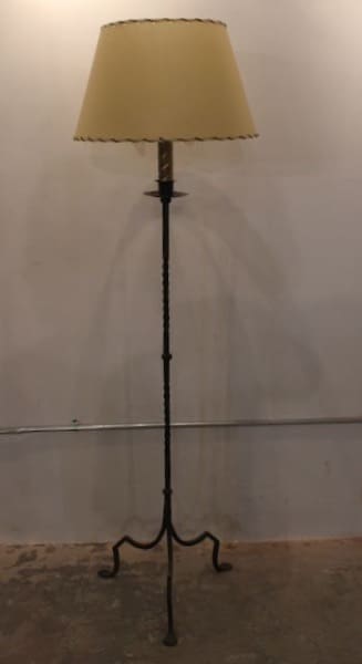 Tall floor lamp with beige lampshade.