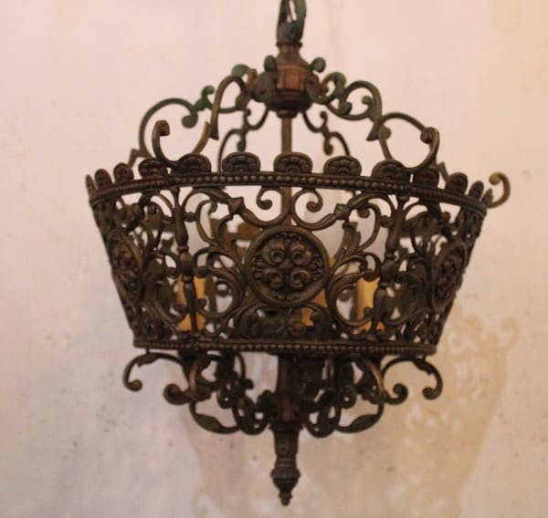 Ornate antique bronze chandelier with intricate design.