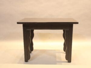 Wooden table with decorative curved legs.