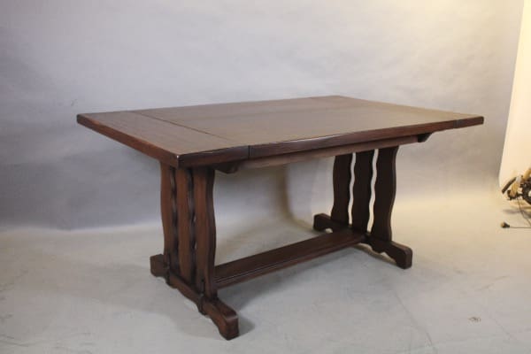 Dark wooden dining table with ornate legs.
