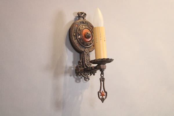 Ornate wall sconce with candle design.