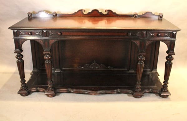 Antique wooden sideboard with ornate design.