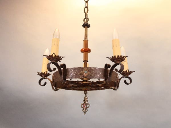 Vintage wrought iron chandelier with candles.