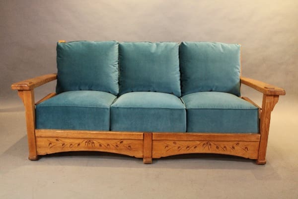 Wooden sofa with blue cushions.