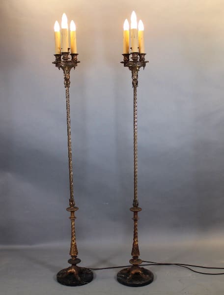 Two ornate tall candlestick lamps lit.
