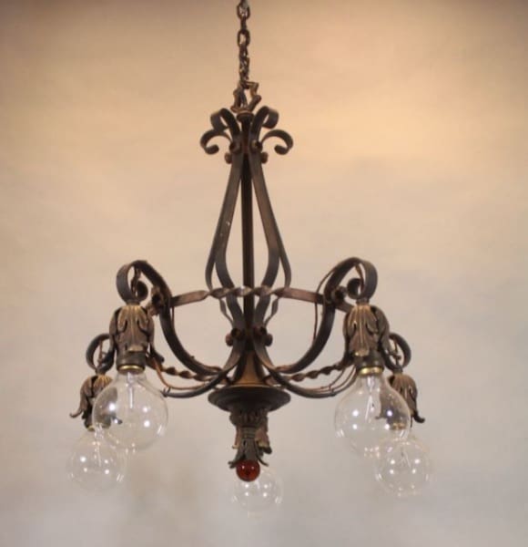 Vintage ornate chandelier with exposed bulbs.