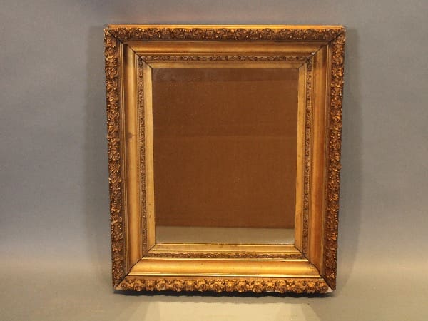Ornate antique mirror with decorative frame.