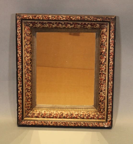 Ornate rectangular mirror with floral frame.