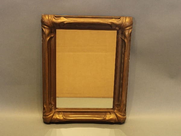 Ornate antique mirror with wooden frame.